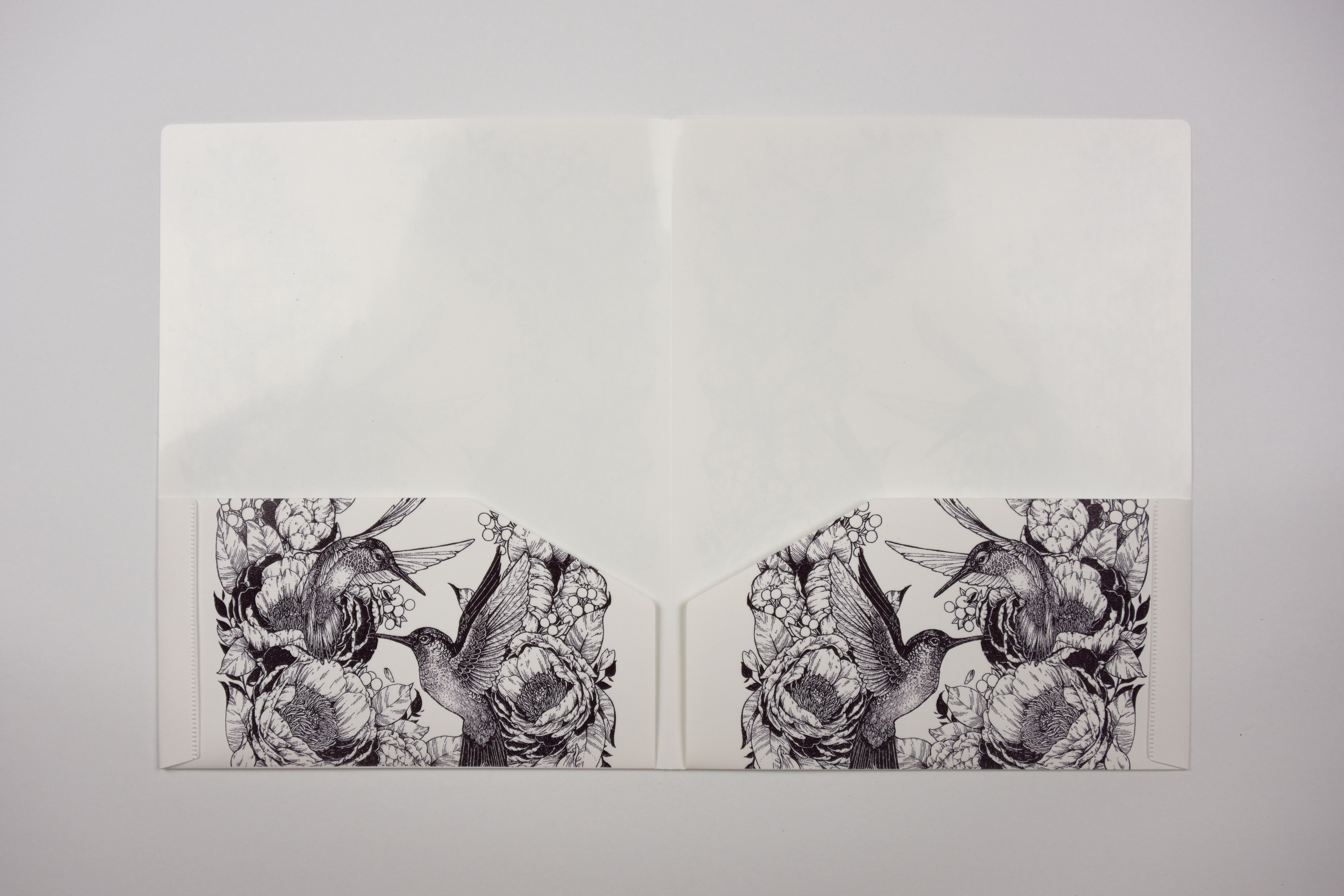 Open folder with illustrations of birds and flowers on a gray background