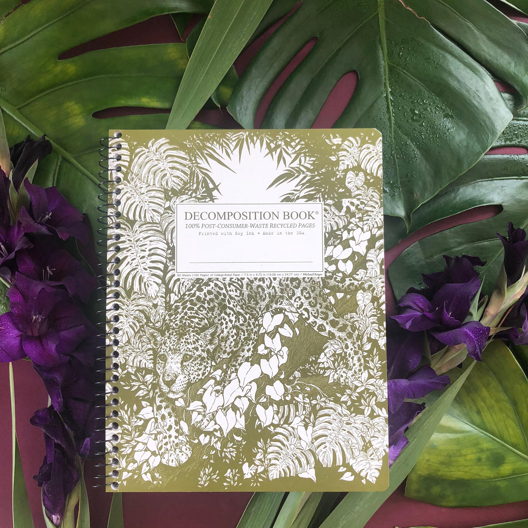 Spiral notebook printed with a jaguar crouched in a forest