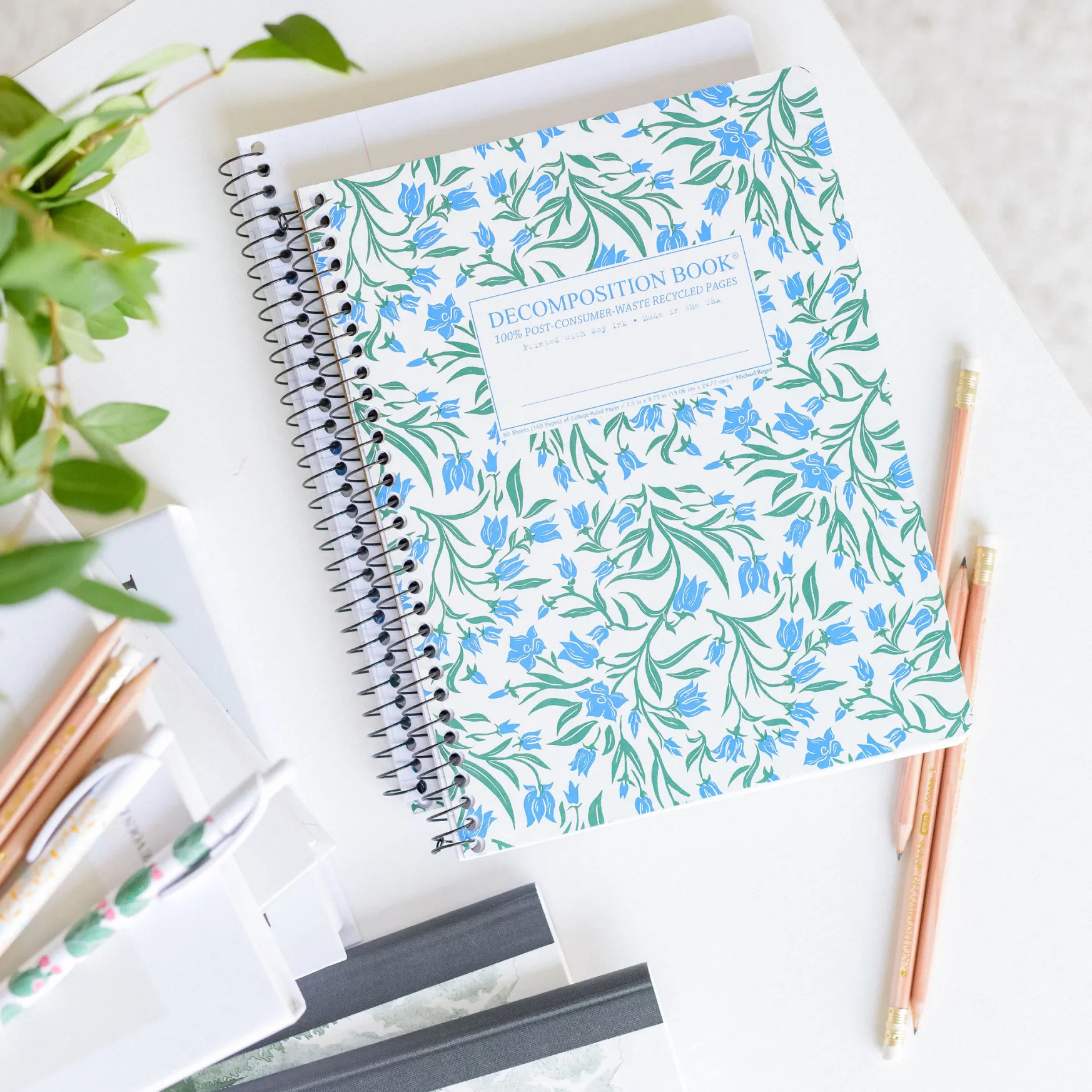 notebook with floral pattern in overhead desk photo
